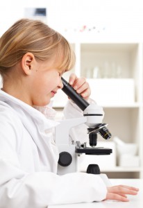 Girl looking in microscope-Shutterstock