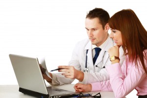 Doctor and patient reviewing health data collected in an EMR.