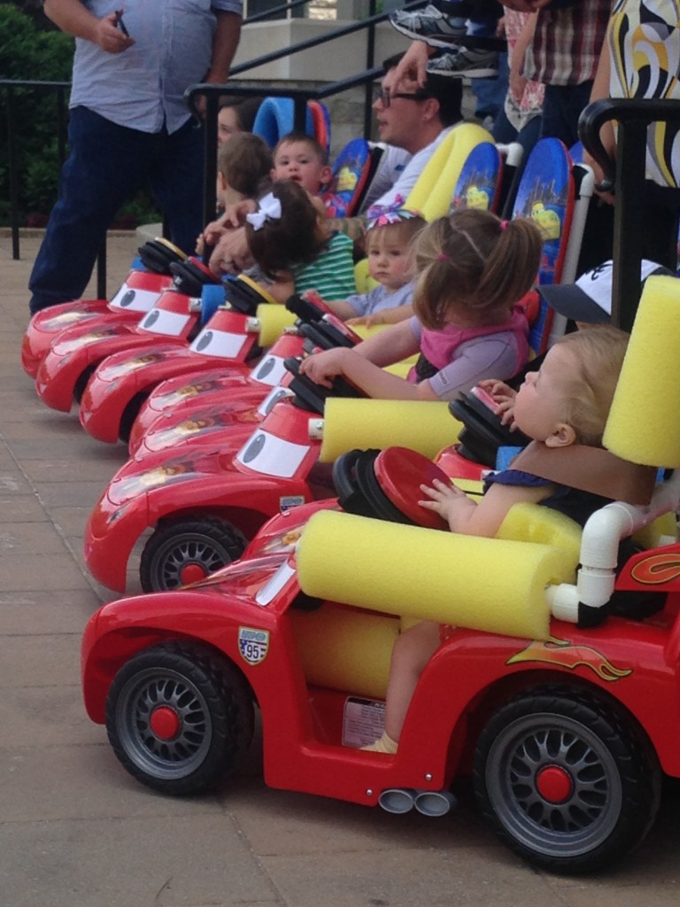 A fleet of toddlers get ready to race in their Go Baby Go cars, customized by therapists and parents to provide disabled children with mobility and help them strengthen weak muscles.